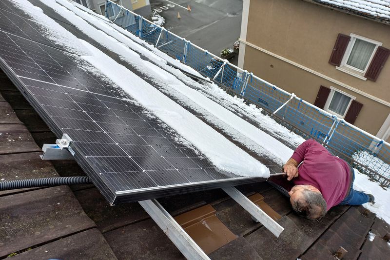 Solar installers working on a rooftop photovoltaic array